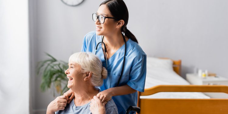 A nurse holding a patient's hand, providing reassurance and comfort through compassionate nurse-patient communication, reducing anxiety in hospitals, and promoting mental health and wellness.