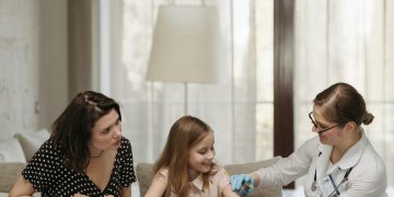 Child holding a worry stone and fidget ring during a pediatric visit, showing how pediatric services help manage childhood anxiety through emotional support and grounding techniques.